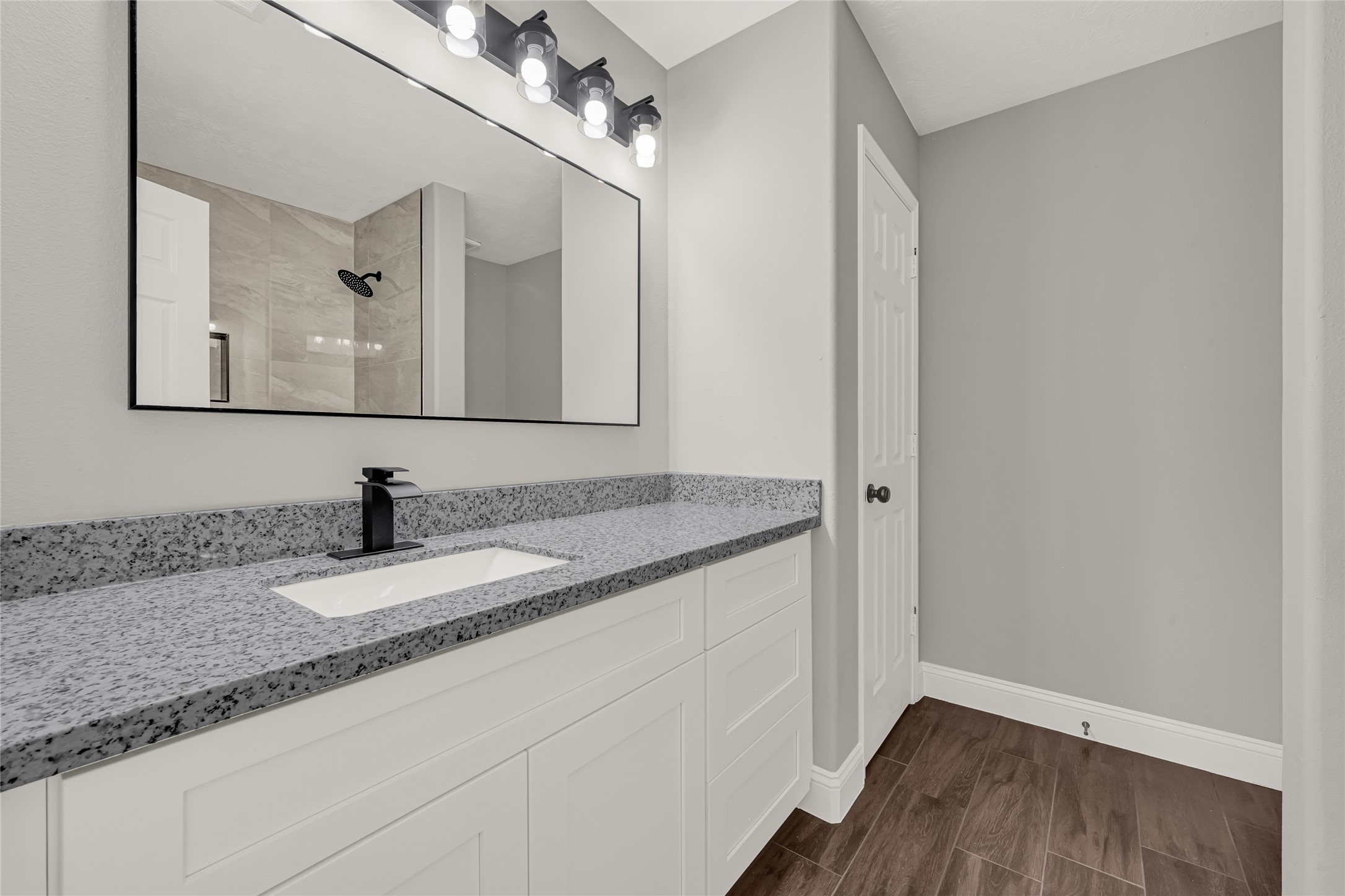 10406 Bentondale Lane Houston, TX 77075 - Photo 21 of 27 a bathroom with a granite countertop sink a mirror and vanity