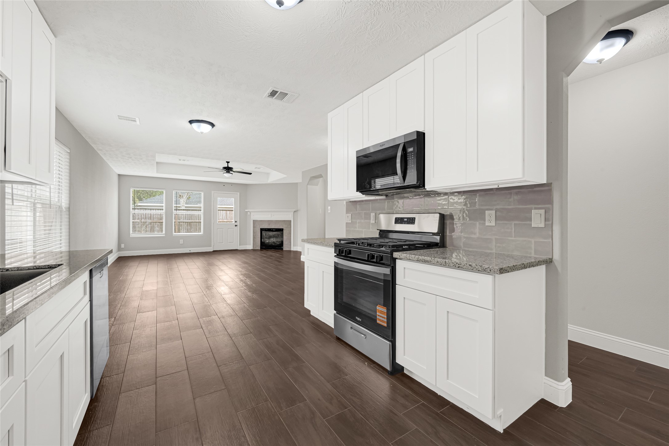 10406 Bentondale Lane Houston, TX 77075 - Photo 7 of 27 a kitchen with granite countertop a stove top oven a sink a counter space and cabinets