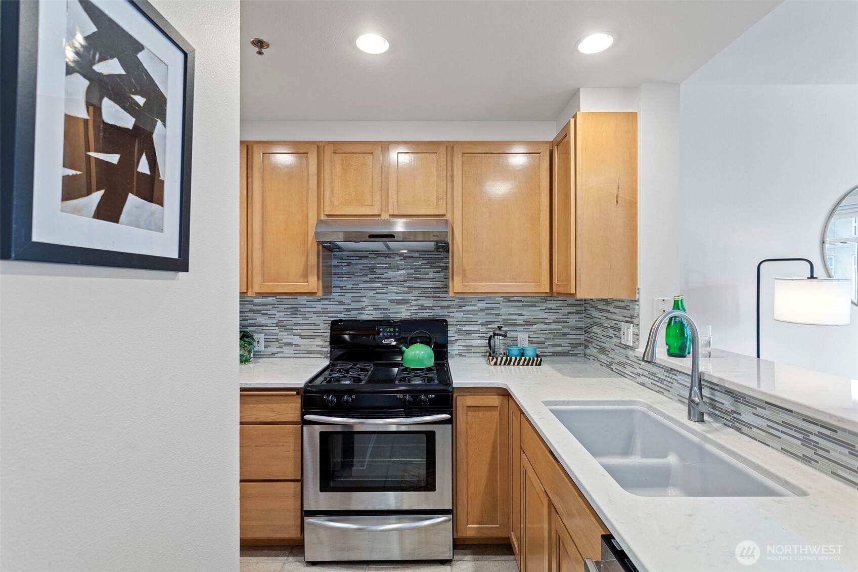 2801 1st Avenue, Unit 612 Seattle, WA 98121 - Photo 12 of 25 a kitchen with stainless steel appliances granite countertop a sink stove and cabinets