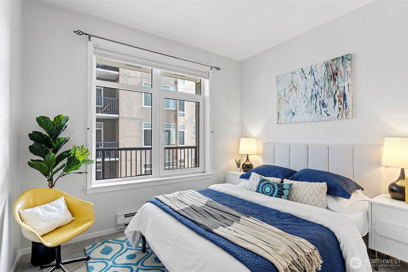 2801 1st Avenue, Unit 612 Seattle, WA 98121 - Photo 14 of 25 a bedroom with a bed a couch and a potted plant on the dresser