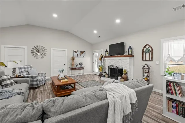 a living room with furniture fireplace and flat screen tv