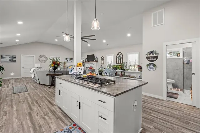 a kitchen with stainless steel appliances granite countertop a stove and cabinets