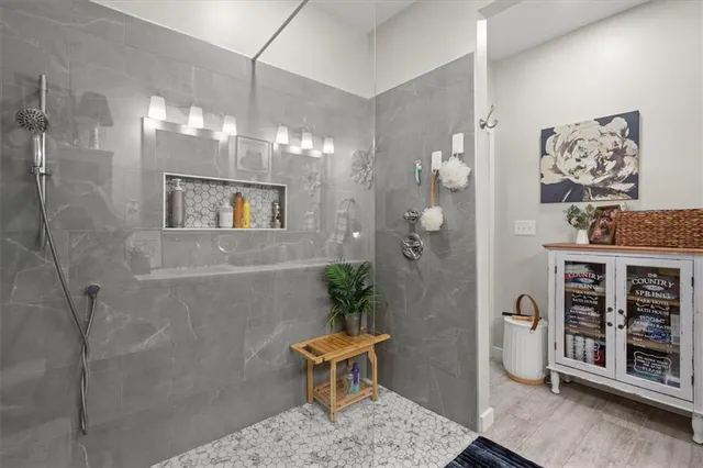 a view of bathroom with a potted plant on the shower
