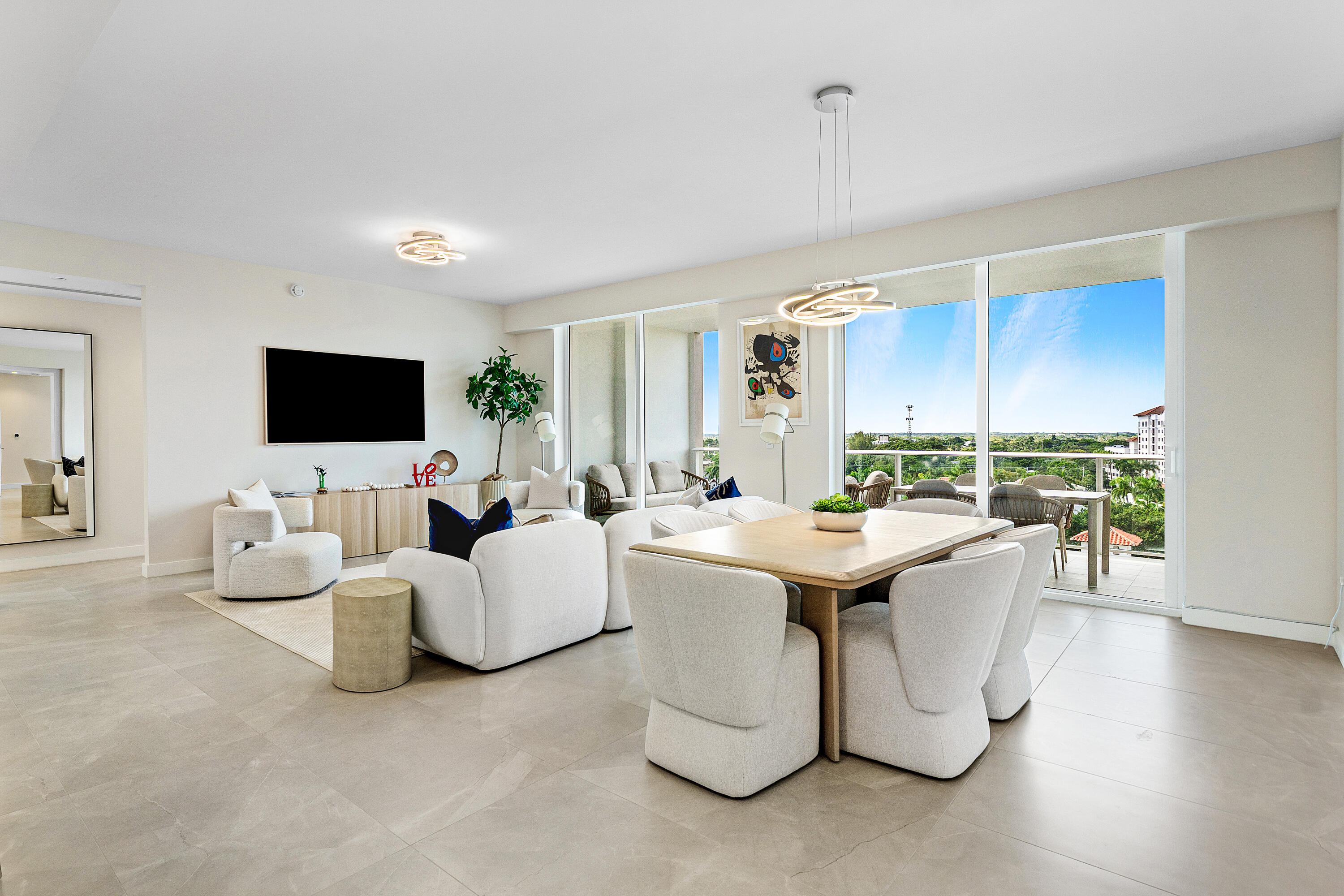 220 Southeast Mizner Boulevard, Unit 810 Boca Raton, FL 33432 - Photo 2 of 39 a living room with furniture and a flat screen tv
