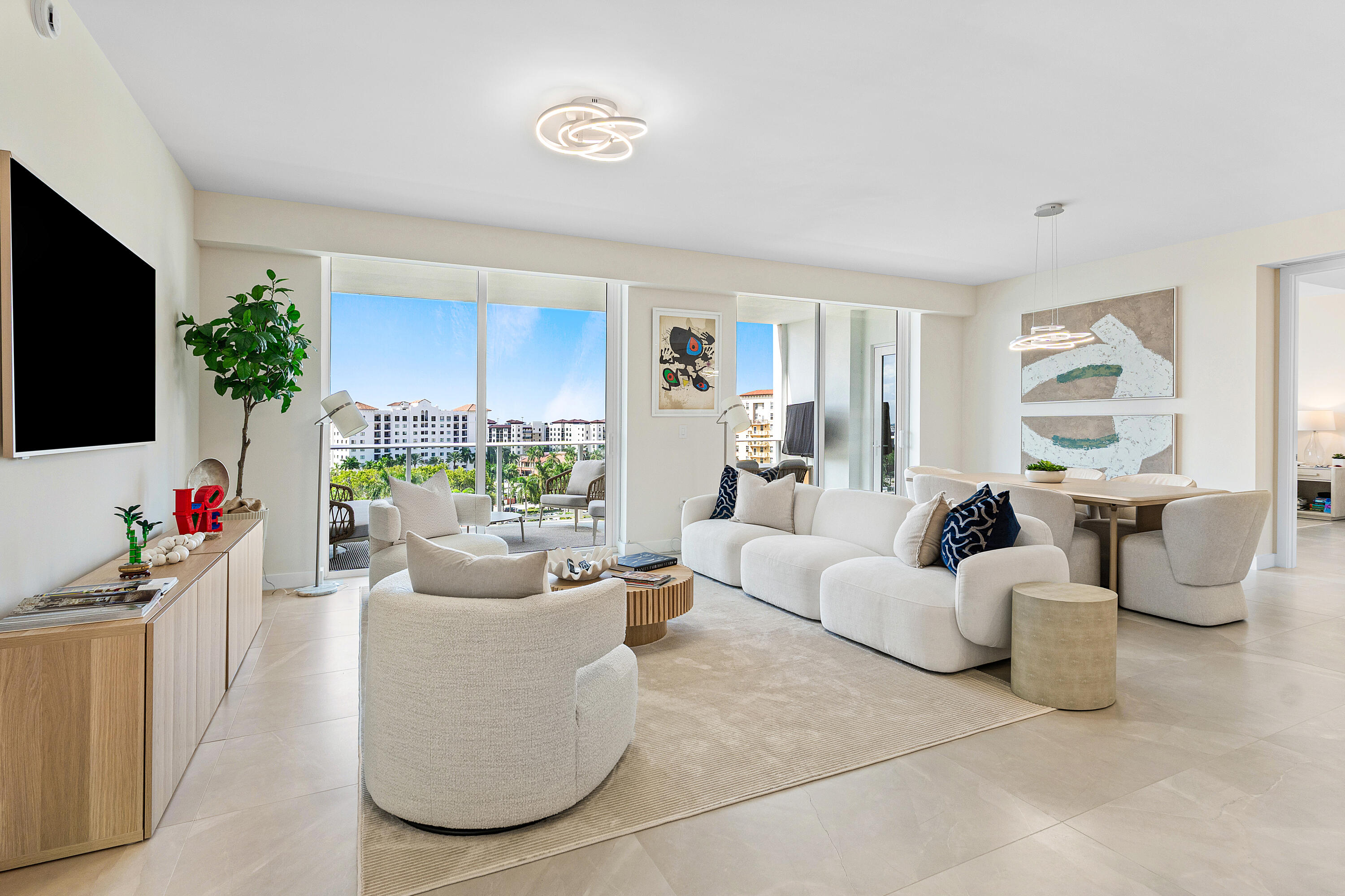 220 Southeast Mizner Boulevard, Unit 810 Boca Raton, FL 33432 - Photo 9 of 39 a living room with fireplace furniture and a flat screen tv