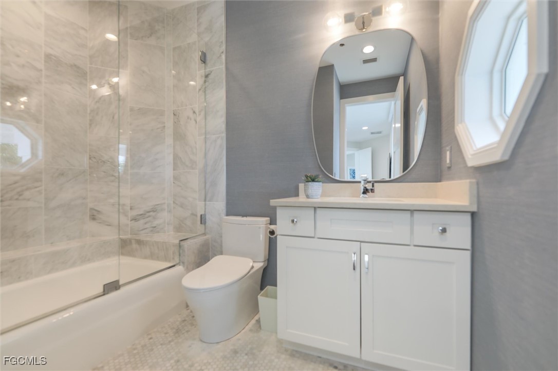 941 South Seas Plantation Road Captiva, FL 33924 - Photo 16 of 50 a bathroom with a bathtub shower sink vanity and toilet