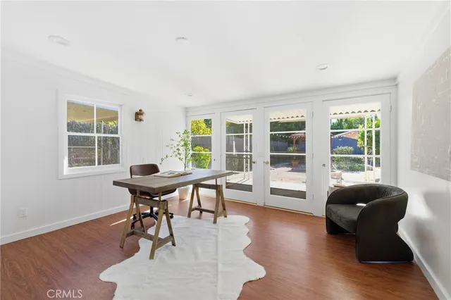 a dining room with furniture and wooden floor