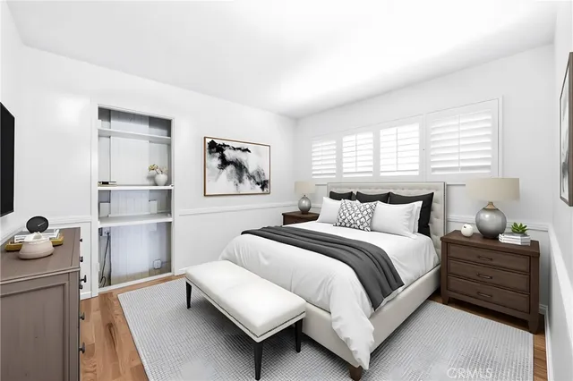 a bedroom with a bed and wooden floor