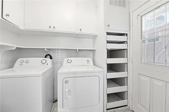 a view of storage and utility room with washer and dryer