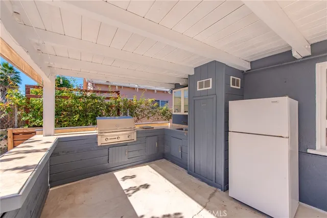 a kitchen with stainless steel appliances granite countertop a refrigerator and a stove