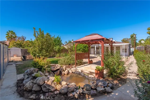 a view of a house with a yard and sitting area