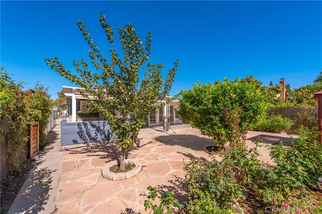 a vase with flowers sitting on a wooden floor