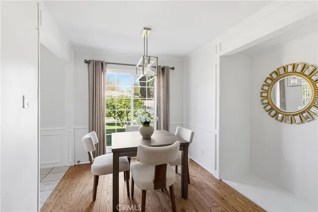 a dining room with furniture a window and a rug