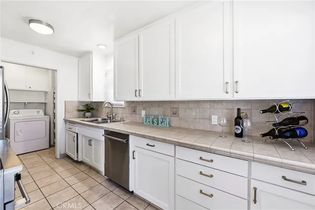 a kitchen with cabinets appliances and a counter top