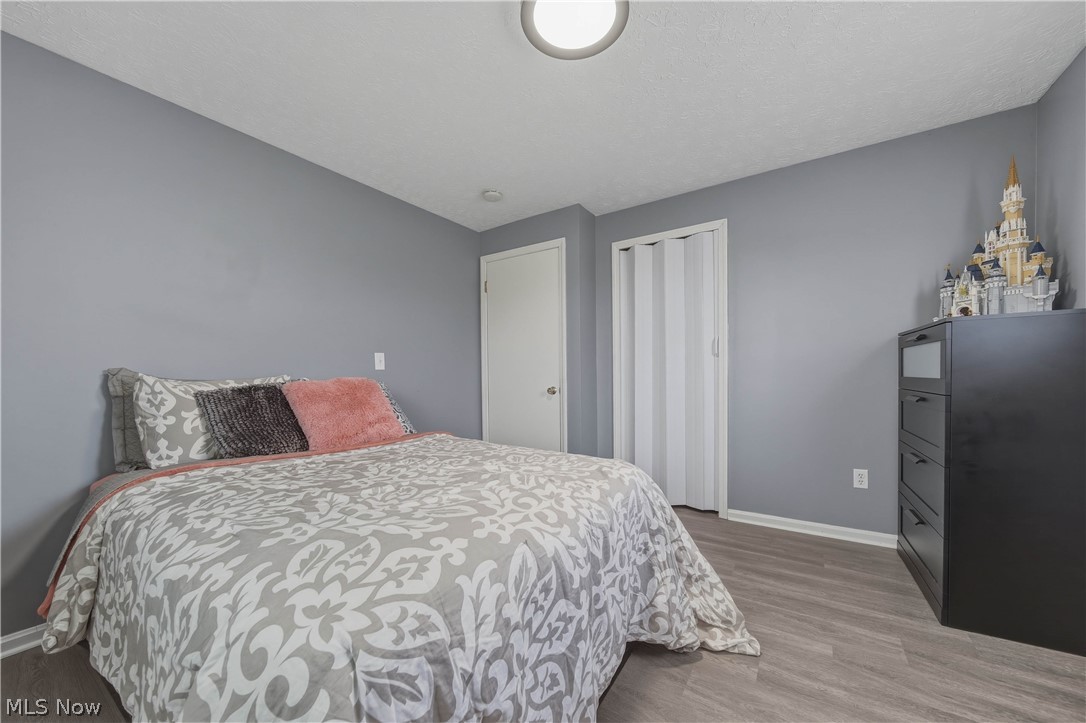 702 Perry Drive Northwest Canton, OH 44708 - Photo 24 of 46 Bedroom with wood finished floors and a closet