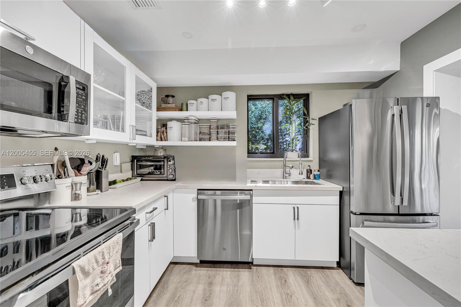 3030 Southwest 2nd Avenue Miami, FL 33129 - Photo 6 of 15 a kitchen with stainless steel appliances granite countertop a stove and a sink