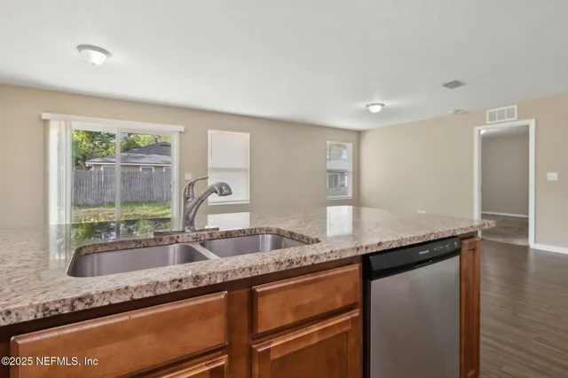 a kitchen with granite countertop a sink and a granite counter tops