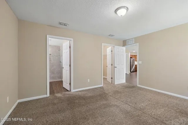 a bathroom with a granite countertop double vanity sink toilet and shower