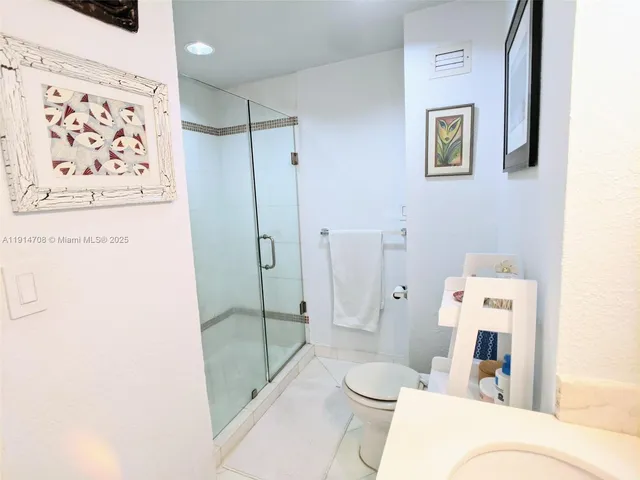 a bathroom with a toilet a sink and shower