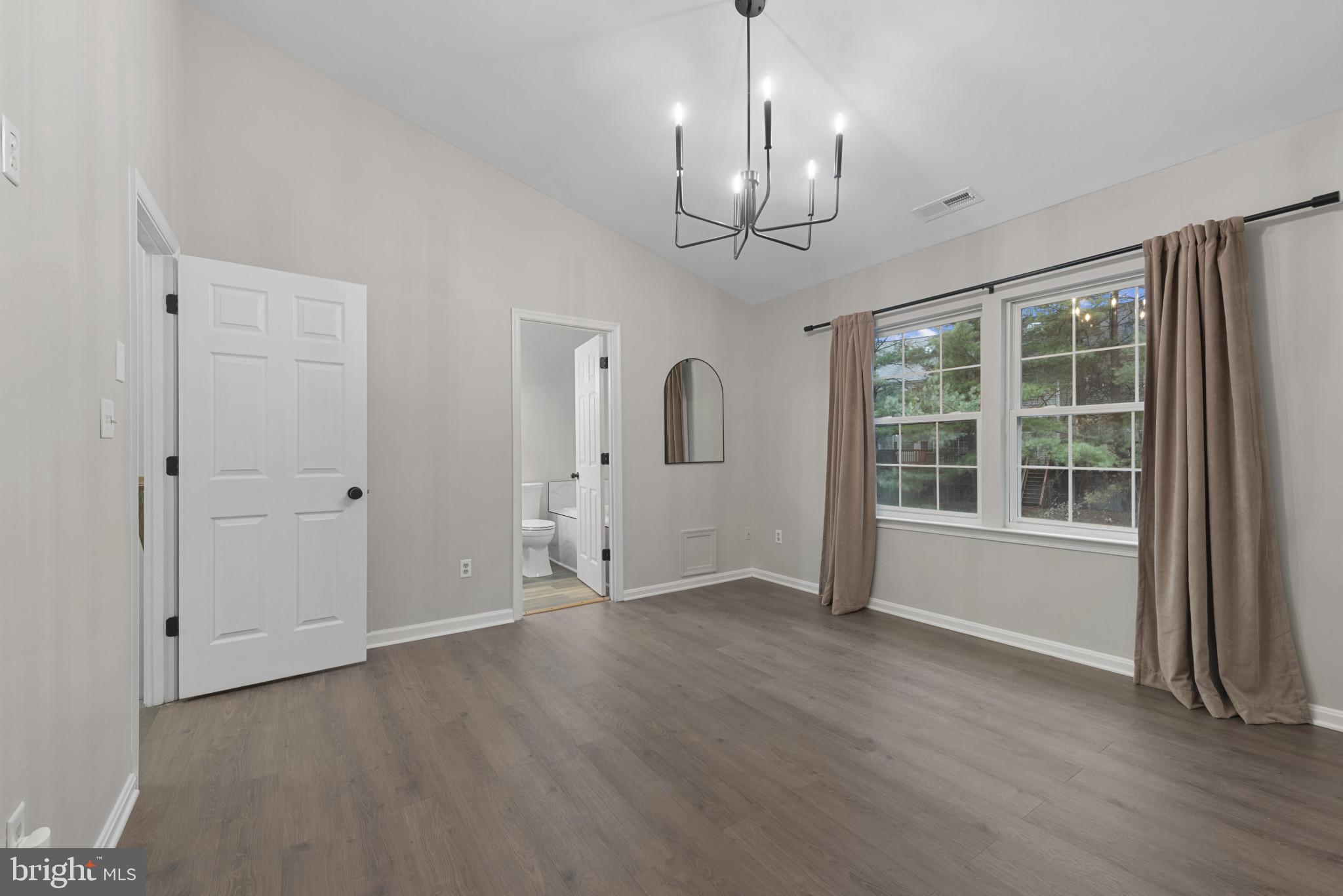 4201 Star Randallstown, MD 21133 - Photo 16 of 30 a view of an empty room with wooden floor and a window