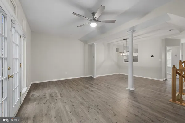 a view of an empty room with wooden floor