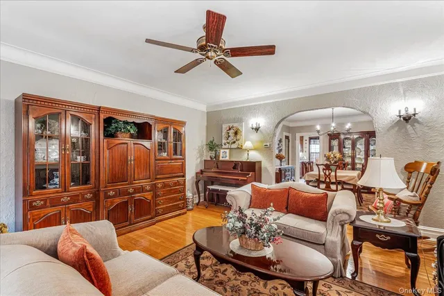 a living room with furniture a chandelier and a dining table