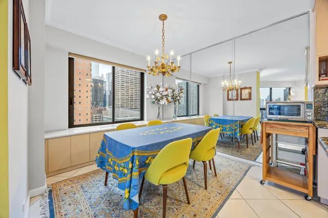 a view of a city from a balcony with furniture