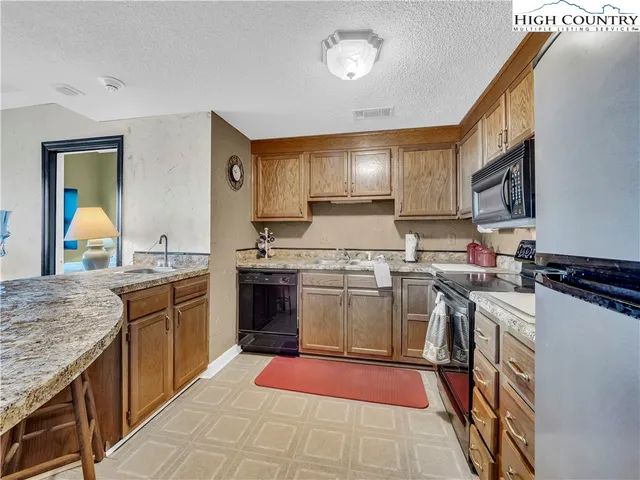 a kitchen with a stove top oven sink and cabinets