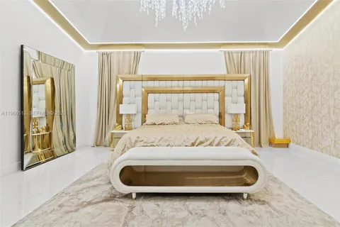 a spacious bathroom with a double vanity sink a large mirror a bathtub and next to a window