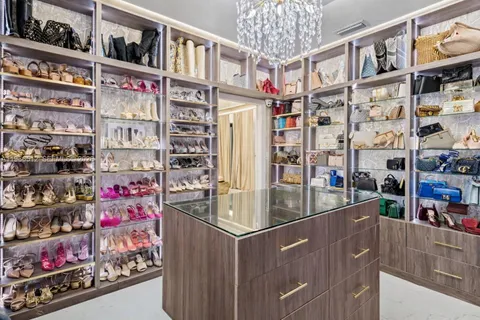 a spacious bedroom with a bed and a chandelier