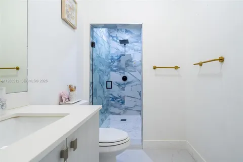 a bedroom with a bed window and a flat screen tv