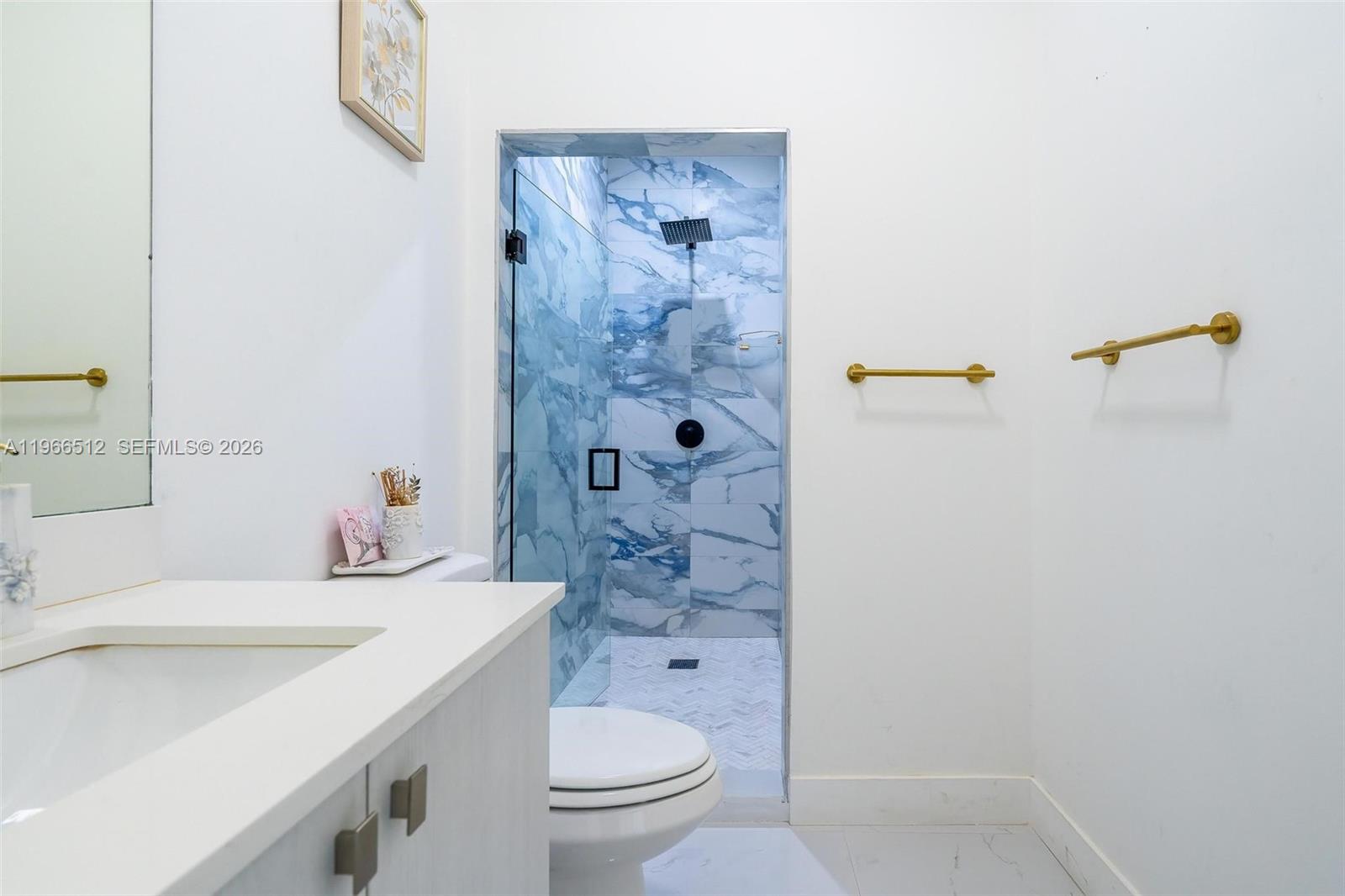 17795 Southwest 158th Street Miami, FL 33187 - Photo 20 of 31 a bathroom with a sink a toilet and shower