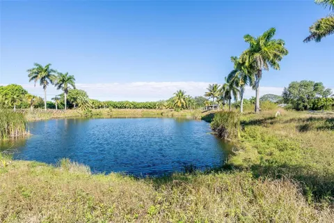 an aerial view of lake residential house with outdoor space and trees around
