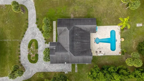 an aerial view of a house with swimming pool