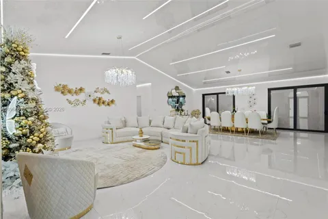 a dining room with furniture and chandelier