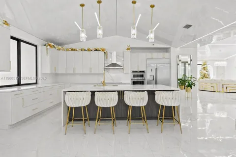 a large white kitchen with a large window