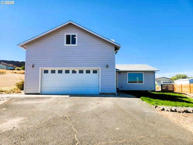 1335 Childers Road Arlington, OR 97812 - Photo 1 of 25 a front view of a house with a yard and garage