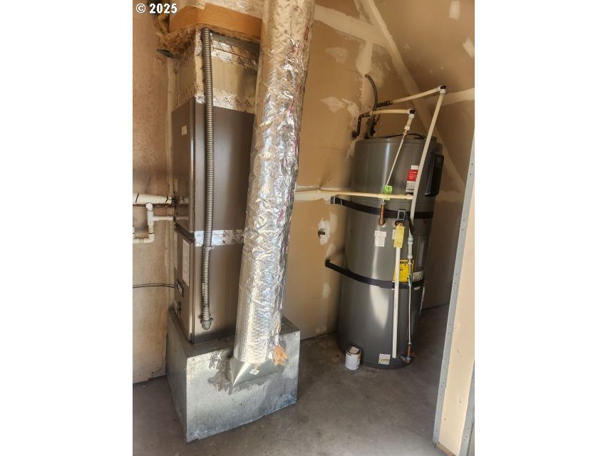 1335 Childers Road Arlington, OR 97812 - Photo 22 of 25 a view of water heater room with a door