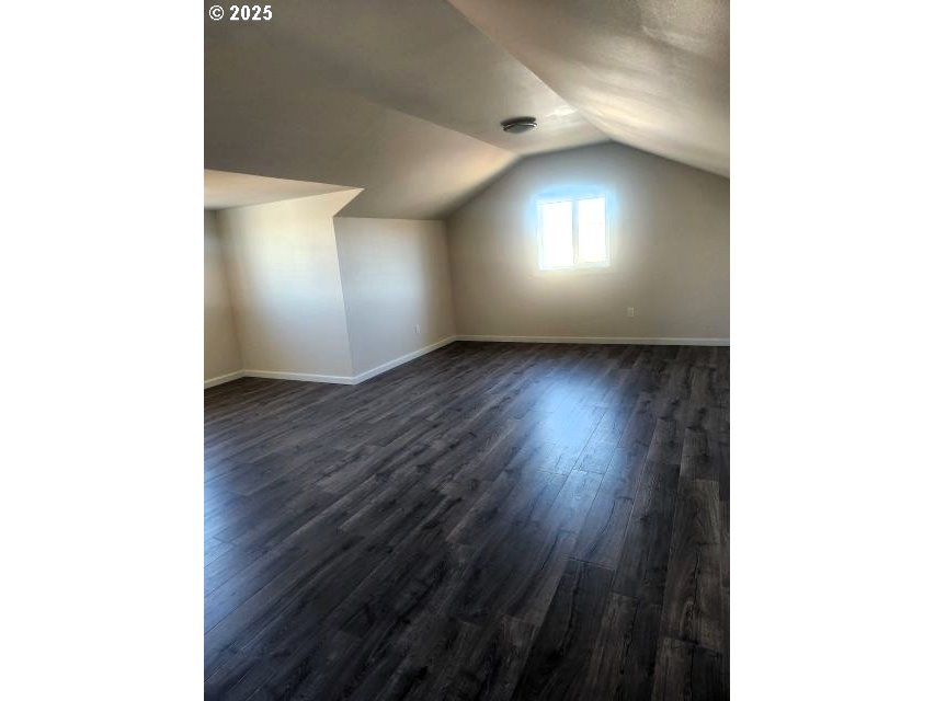1335 Childers Road Arlington, OR 97812 - Photo 23 of 25 a view of an empty room with wooden floor and a window