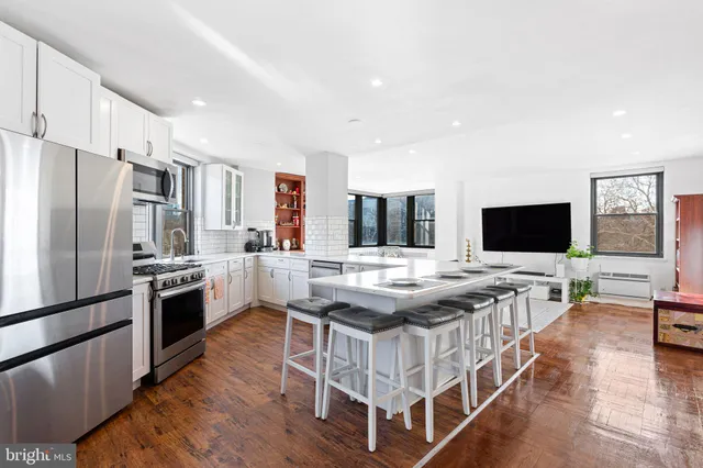 a kitchen with stainless steel appliances granite countertop a stove and a refrigerator