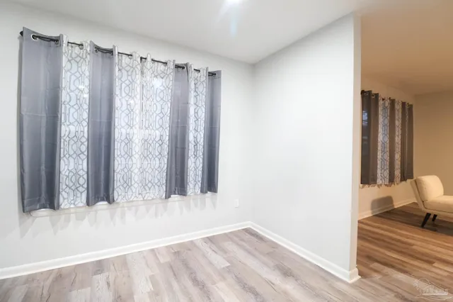 a view of a room with window and wooden floor