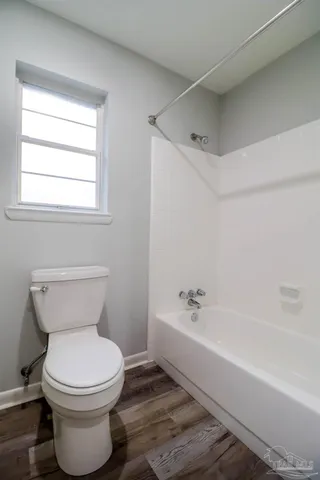 a bathroom with a toilet and a bathtub