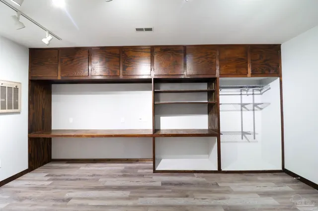 a view of a room with wooden floor