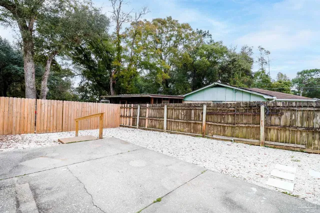 a view of wooden fence and a trees