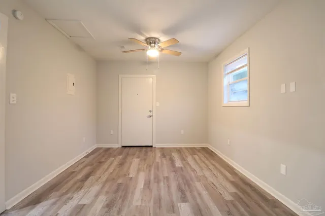 a view of room with hardwood floor and ceiling fan