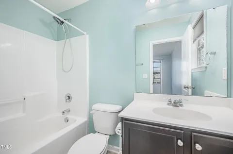 an empty room with closet and a chandelier fan