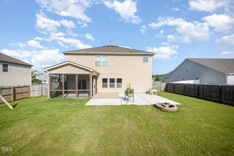 an aerial view of a house with a swimming pool outdoor seating and yard