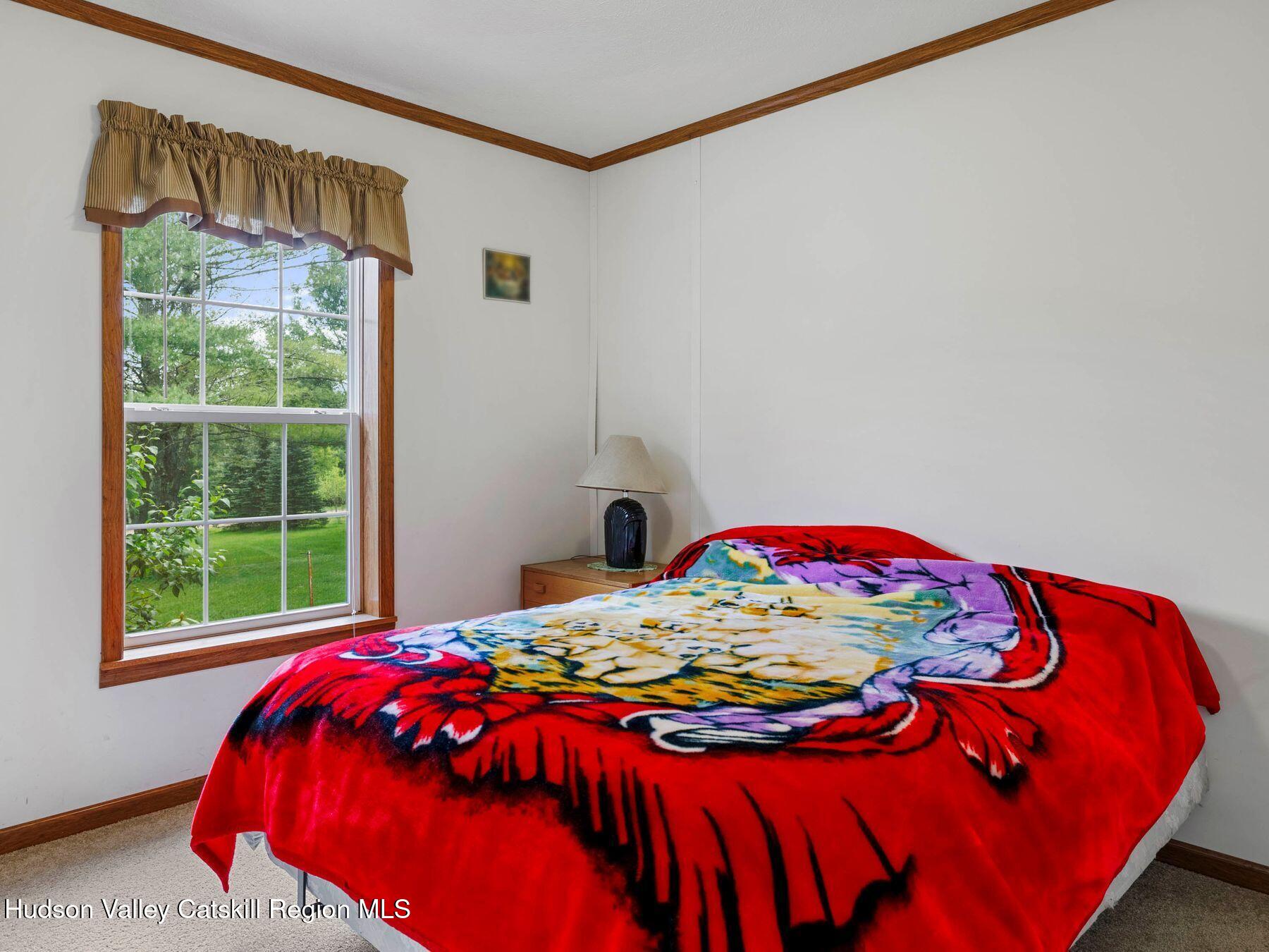 137 Mountain Pond View Road Gilboa, NY 12076 - Photo 33 of 38 a bedroom with a bed and a window