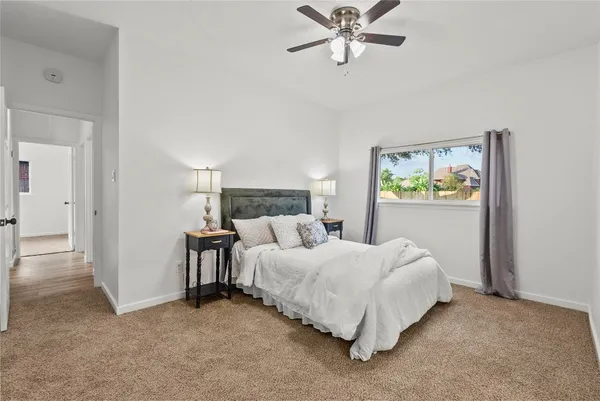 a bedroom with a bed and painting on the wall