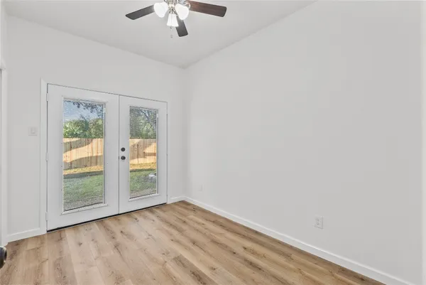 wooden floor in an empty room with a window